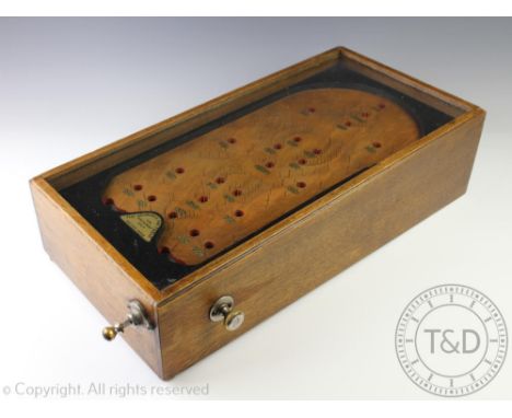 A Bagatelle pin ball game, 'The Advance Pin Table, for amusement only, British Made' in glazed oak case, 58cm x 29cm