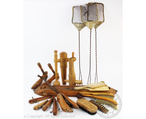A selection of assorted 19th century and later wooden tools to include shoe lasts, barrel taps and butter pats, three vintage