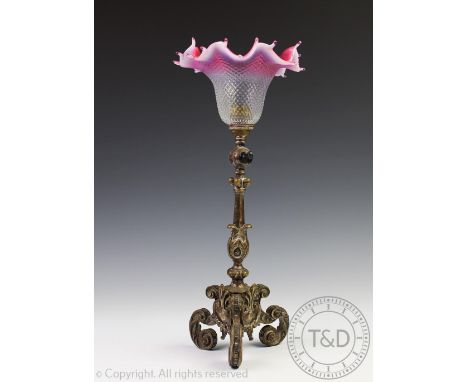 An Edwardian Silver plated lamp base, of rococo style with scroll and leaf cast detailing, with crimped cranberry shade, 38cm