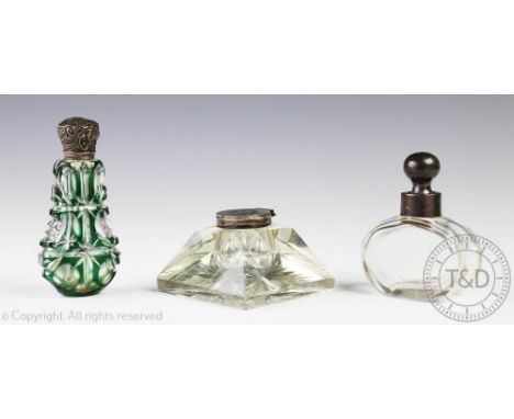 A silver mounted scent bottle, with green faceted glass body, 10.5cm high, a further silver mounted scent bottle of simplisti