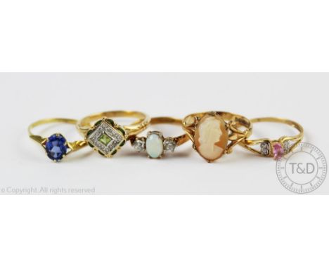 A selection of gem set rings, each set in yellow metal to include 9ct and 14ct examples and a carved shell cameo set 9ct gold