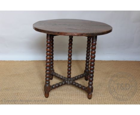 An early 18th century and later oak circular occasional table, on bobbin legs, 65cm H x 74cm diam, (converted), with a George