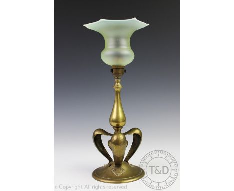 An Art Nouveau brass lamp base in the style of William Arthur Smith Benson, designed with a central turned column with trefoi
