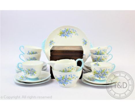 A Shelley twenty one piece tea service, decorated with forget me nots, with an early 19th century inlaid tea caddy (22)