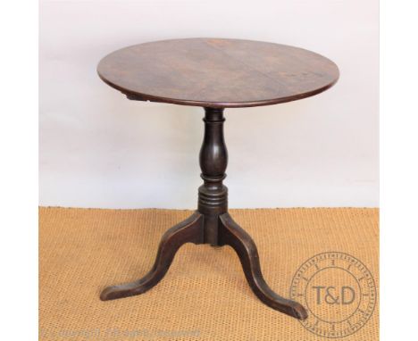 A George III oak occasional table, circular three plank top, on a turned column and tripod base, 70cm H x 72cm W