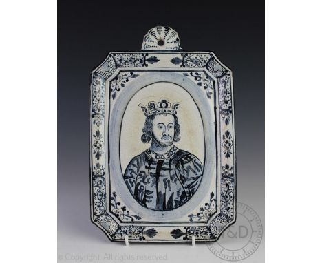 A late 19th century Dutch earthenware portrait plaque, painted in blue and white with a portrait of a King, 29cm CONDITION RE