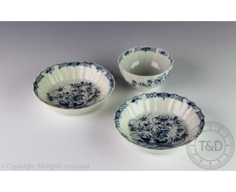 A Worcester blue and white porcelain large size fluted tea bowl and two saucers, circa 1770, each painted in blue with the 'H