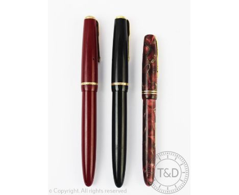 Two Parker Duofold fountain pens, each with a '14k' nib and engine turned banding to the exterior, black and burgundy cases w