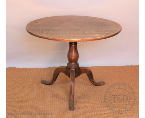 A George III oak occasional table, with circular three plank top, on turned column and tripod base, 91cm H x 70cm diam