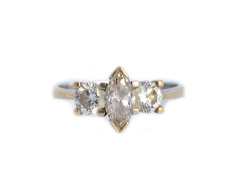 A white gold and diamond set three stone ring, claw set with the marquise shaped diamond at the centre, between two circular 