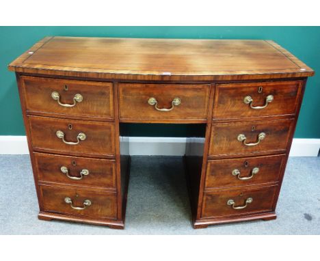 A George III mahogany bowfront seven drawer side cabinet, on bracket feet, 135cm wide x 87cm high.