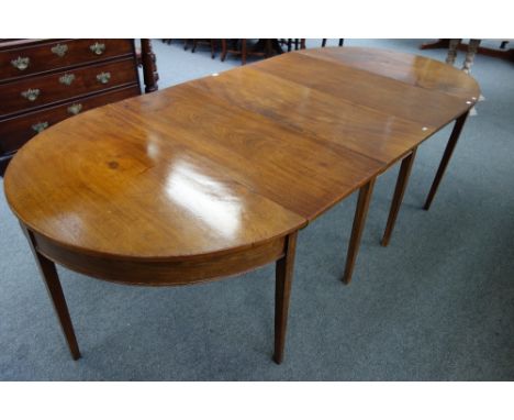 A George III mahogany D-end extending dining table, with drop-flap centre section and one extra leaf, 121cm wide x 259cm long