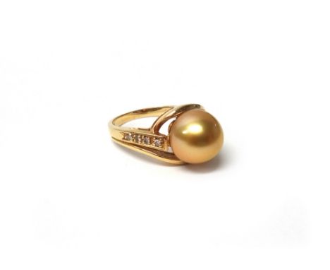 A gold, cultured pearl and diamond ring, mounted with the gold tinted cultured pearl at the centre, between circular cut diam