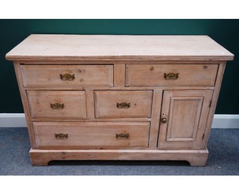 An early 19th century pine dresser base, with five various drawers and cupboard, on bracket feet, 134cm wide x 88cm high.