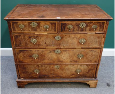 An early 18th century figured walnut chest of two short and three long graduated drawers, on bracket feet, 101cm wide x 91cm 