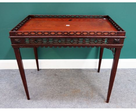 A 19th century mahogany silver table of George III design, the rectangular top with fret pierced gallery and frieze, on taper