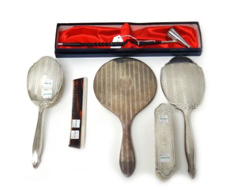 Silver and silver mounted wares, comprising; a hand mirror, Birmingham 1916, a composite four piece dressing set, comprising;