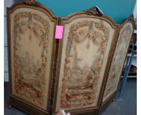 A late 19th century French gilt framed arch top three fold screen, with inset tapestry panels, 207cm wide x 156cm high.  