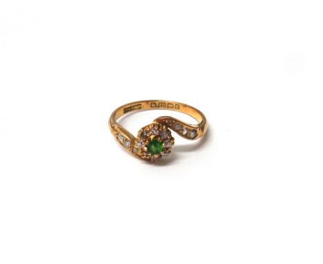 An 18ct gold, demantoid garnet and diamond set cluster ring, mounted with the demantoid garnet (very rubbed) at the centre, i