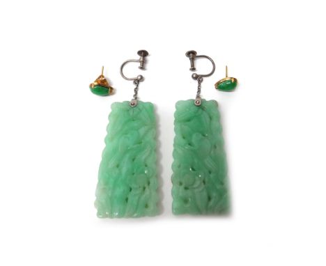 A pair of carved jade pendant earrings, each in a tapered drop shaped design, with carved and pierced decoration, the tops wi