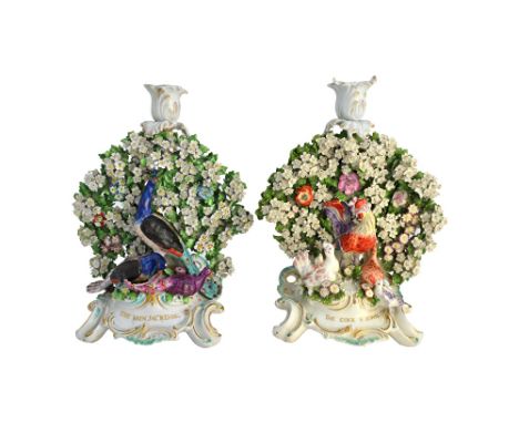 A pair of Chelsea-Derby fable candlestick groups of `The Cock & Jewel' and `The Vain Jackdaw', circa 1770-75, with a cockerel