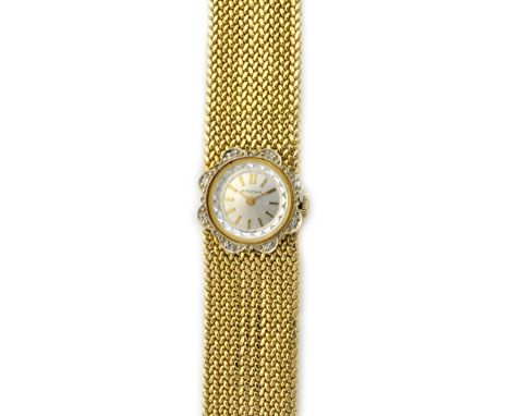 A Juvenia gold and diamond set lady's bracelet wristwatch, the signed circular silvered dial with gilt baton shaped numerals,