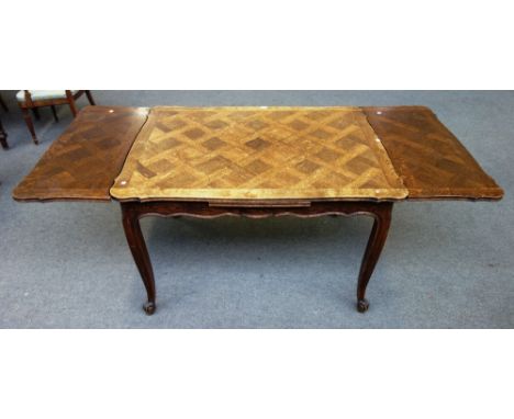 A late 19th century/early 20th century ash and oak parquetry inlaid draw-leaf dining table, on scroll supports, 90cm wide x 1