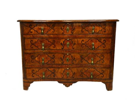 A mid 18th century German ivory inlaid walnut serpentine four drawer commode, 130cm wide x 94cm high.  Illustrated