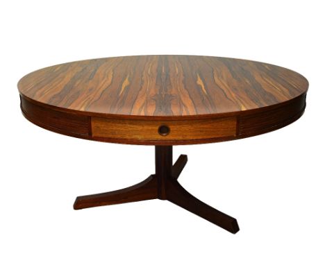 Archie Shine for Heals; a 20th century circular rosewood dining table, with turned column on three supports, 142cm wide x 71c