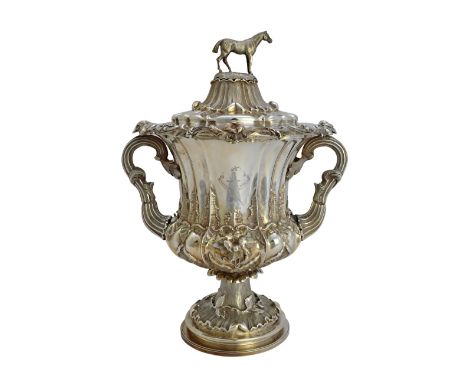 A William IV silver twin handled trophy and cover, of campana shaped form, having foliate capped rustic handles, the body dec