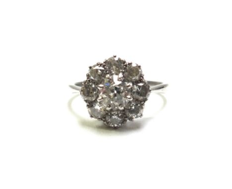 A diamond set nine stone cluster ring, claw set with the principal cushion shaped diamond at the centre in a surround of eigh