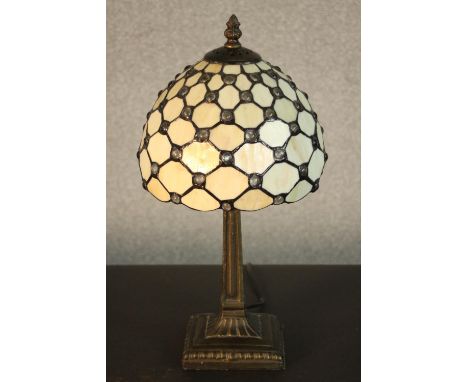 A reproduction Tiffany style table lamp, with a dome shaped stained glass shade on a columnar base. H.48 Dia.27cm. 