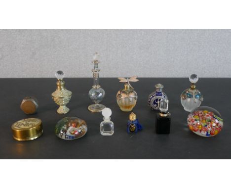 A collection of embellished scent bottles, paperweights and a penny cigarette lighter. H.13cm (largest) 