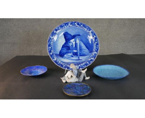 A collection of plates and a ceramic figure, including a Royal Copenhagen hand painted porcelain figure of a couple lying dow