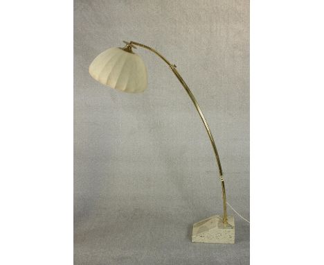 A 1970s brass arc floor lamp, of tubular extending form with a lobed fabric shade, on a marble base. H.167cm.