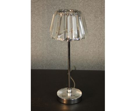 A table lamp with a prismatic glass shade, on a tubular chromed stem with a circular base. H.37 Dia.13cm. 