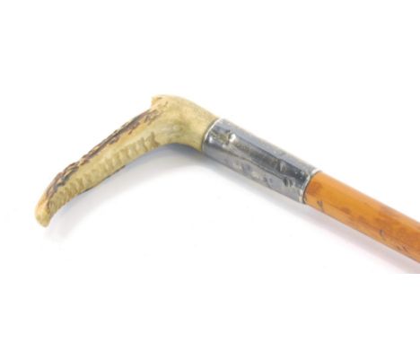 A Victorian hunting whip, with turned fruit wood stem, silver collar London 1893 and horn handle, 68cm long.