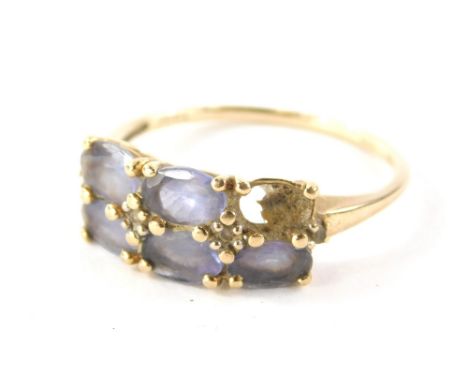 A 9ct gold amethyst dress ring, set with six oval amethysts (1 missing), in claw setting with tiny cz set shoulders, the band