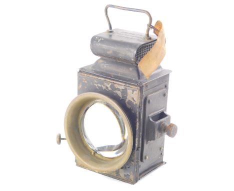 An early 20thC Raydoyt car lamp, with shaped metal case, fixed handle and circular dome glass front, 25cm high.