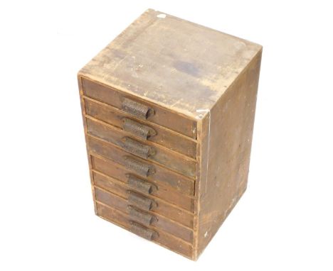 An early 20thC eight drawer tool cabinet, with metal cup handles, revealing a quantity of watch faces, costume jewellery, var