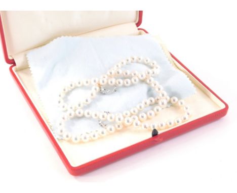 A Mikimoto pearl necklace, with pink luster pearls approximately 6mm wide, on a string strand with M motif, with two interlin