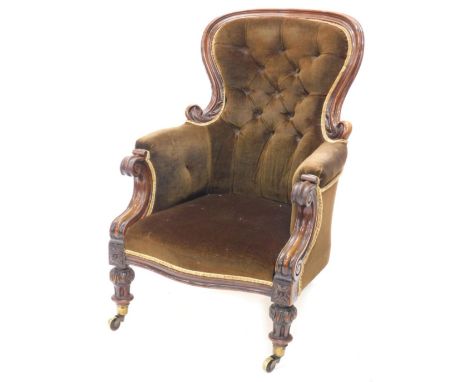 An early Victorian mahogany show frame armchair, with a button padded back and sides, scroll carved arms supports on turned a
