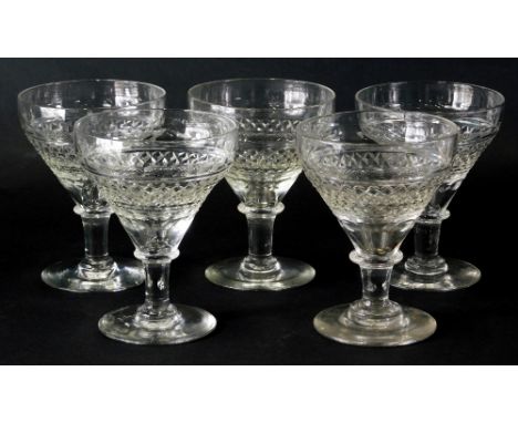 A set of five 19thC crystal glass wine glasses, with deep bowls, partially hobnail cut on turned stems and circular feet with