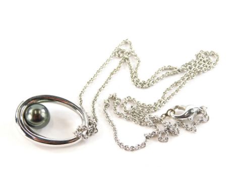 An 18ct white gold Mikimoto pearl necklace, the oval pendant set with blackened finished pearl, 2.5cm high, on a white gold c