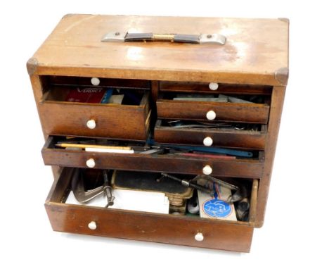 A early 20thC mahogany tool chest, with an arrangement of small drawers, containing a quantity of tools, bits, drill heads, w