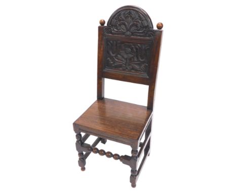 A 17thC and later oak side chair, the back carved with stylised tulips, etc., with a later solid seat on bobbin turned suppor