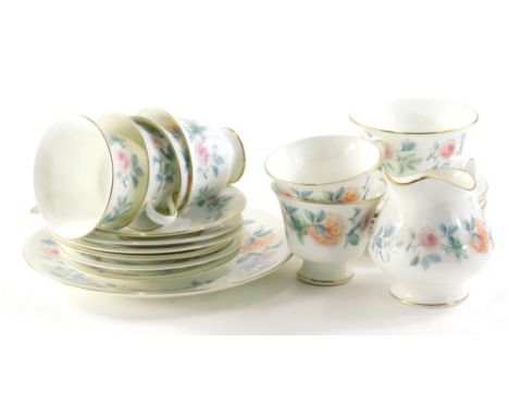 A Wedgwood Mist Rose part tea service comprising service plate, 24cm diameter, cups, saucers, side plated, milk jug and sugar