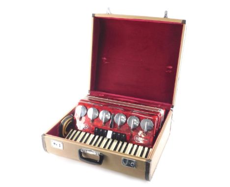 A mid 20thC Parrot piano accordion, in red, with bank of six buttonS, 47cm wide. (cased) 