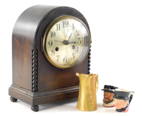 An early 20thC oak mantel clock, the domed case holding a 13cm diameter Arabic dial, flanked by barley twist columns on orb f