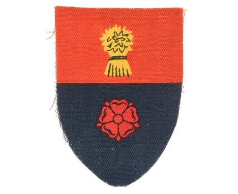 94th Army Group, Royal Artillery formation sign badge circa 1947-48.  Red over blue shield. Top printed with yellow wheatshea